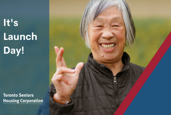 A senior tenant smiles and gives a wave. The text says "It's Launch Day!" with the Toronto Seniors Housing Corporation wordmark.